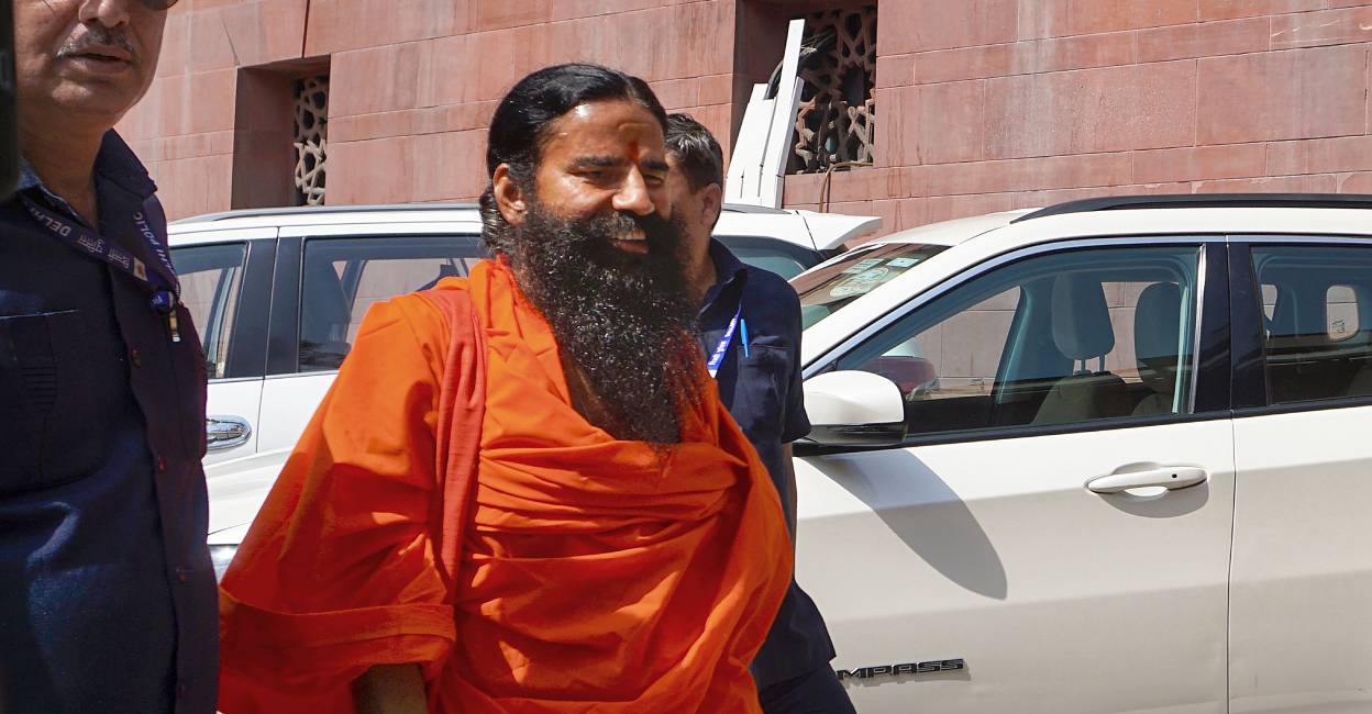 Yoga guru Ramdev arrives at the Supreme Court for hearing on the Patanjali misleading advertisements case. Photo: PTI