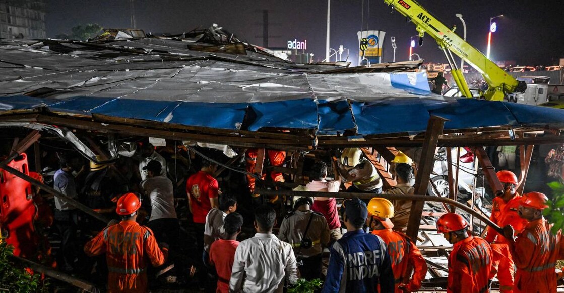 hoarding-collapse-mumbai National Disaster Response Force (NDRF) personnel look for survivors during a rescue operation at the site . Photo: AFP