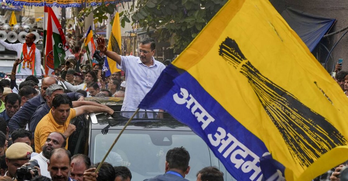 Delhi Chief Minister Arvind Kejriwal waves to supporters during a roadshow for Lok Sabha polls, in New Delhi. Photo: PTI