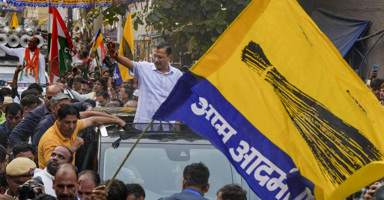 Delhi Chief Minister Arvind Kejriwal waves to supporters during a roadshow for Lok Sabha polls, in New Delhi. Photo: PTI