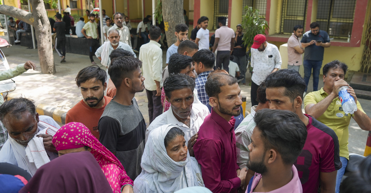 Family members cry at a mortuary where bodies of newborns are kept at GTB hospital in Delhi. Photo: Atul Yadav/PTI.