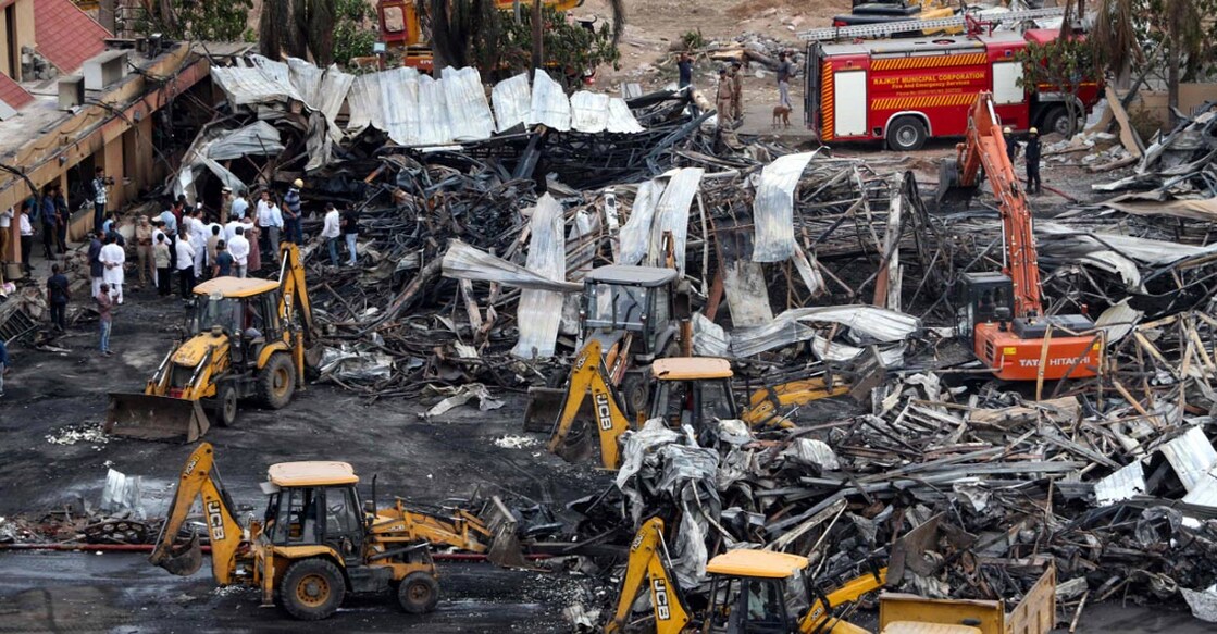 rajkot-fire-ls Officials clear charred remains at the site of a fire accident on the following day of the disaster, at an amusement park facility in Rajkot. Photo: AFP via PTI.