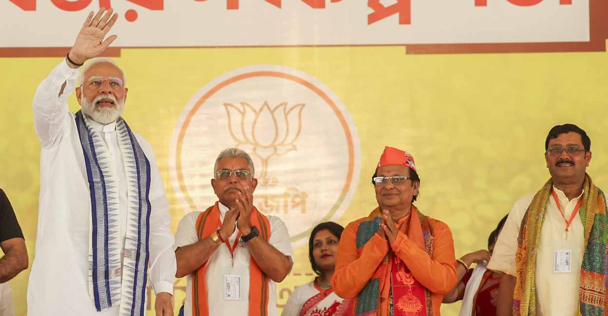 **EDS: HANDOUT IMAGE** Purba Bardhaman: Prime Minister Narendra Modi waves to supporters during a public meeting at Bardhaman, ahead of the third phase of Lok Sabha elections, in Purba Bardhaman district. (PTI Photo) (PTI05_03_2024_000053B)