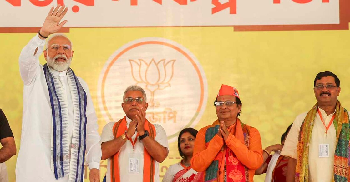 PTI05_03_2024_000053B **EDS: HANDOUT IMAGE** Purba Bardhaman: Prime Minister Narendra Modi waves to supporters during a public meeting at Bardhaman, ahead of the third phase of Lok Sabha elections, in Purba Bardhaman district. (PTI Photo) (PTI05_03_2024_000053B)