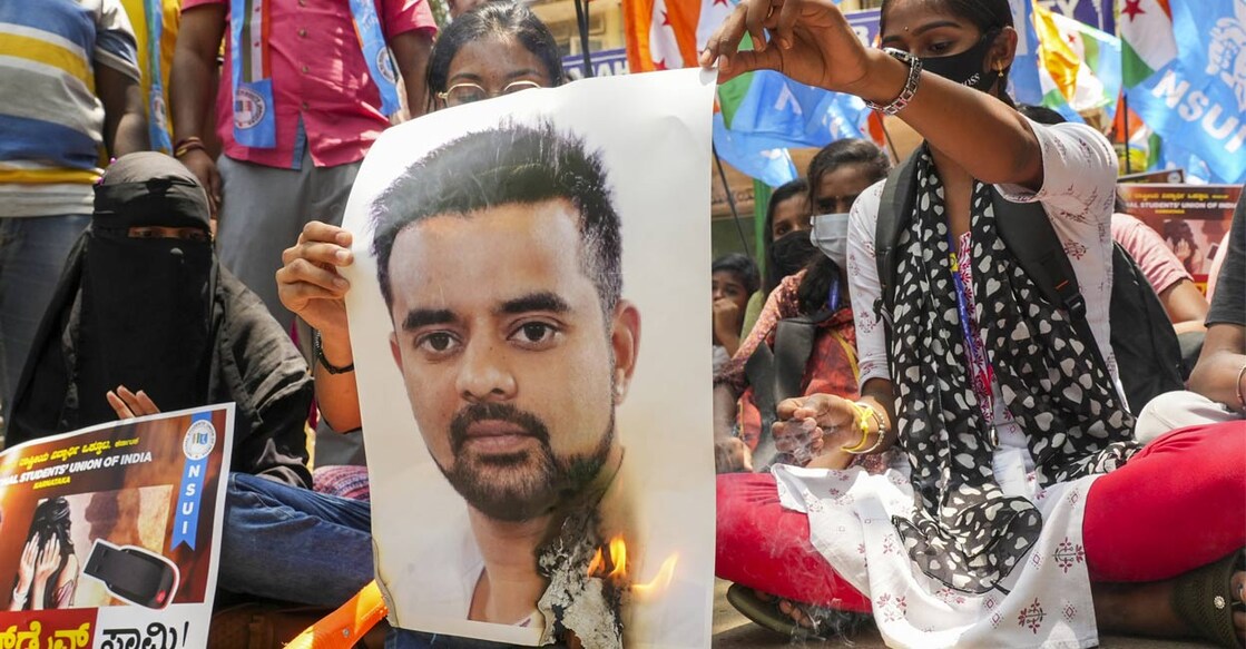 NSUI members burn a poster of JD(S) MP Prajwal Revanna during a protest against his involvement in the alleged sexual abuse case, in Bengaluru, Tuesday, April 30, 2024. Photo: PTI. 