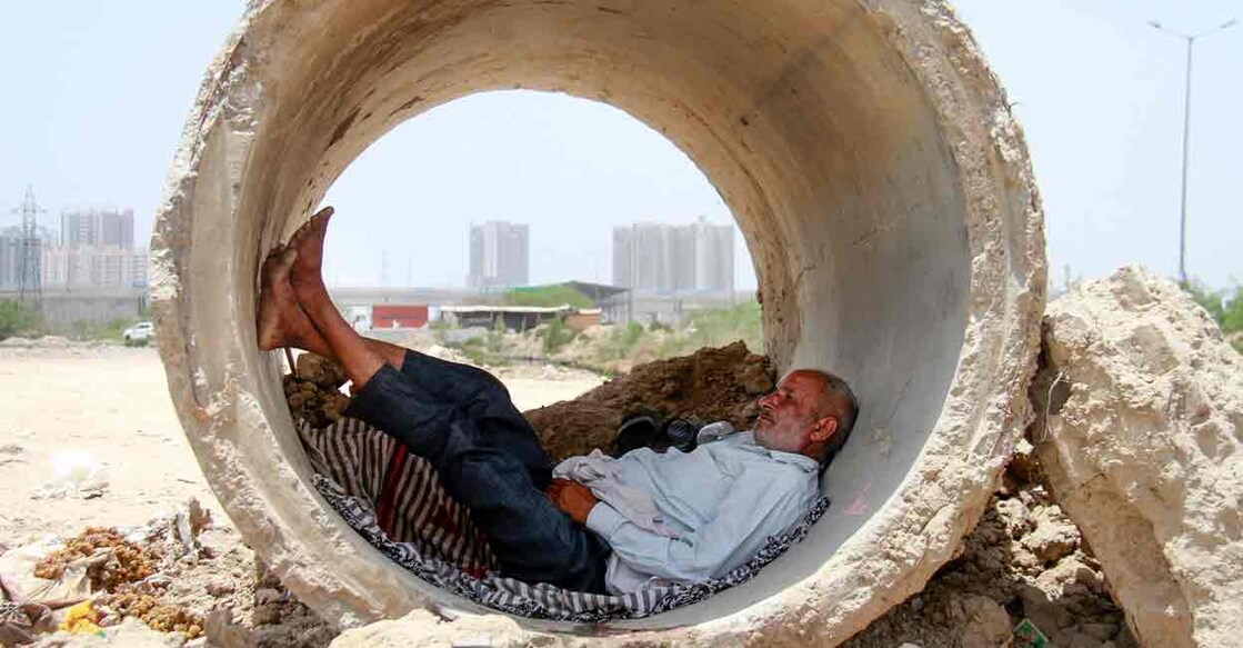  A man takes refuge inside a concrete pipe from the scorching heat on a hot summer day, in Gurugram, Thursday, May 30, 2024. Photo: PTI