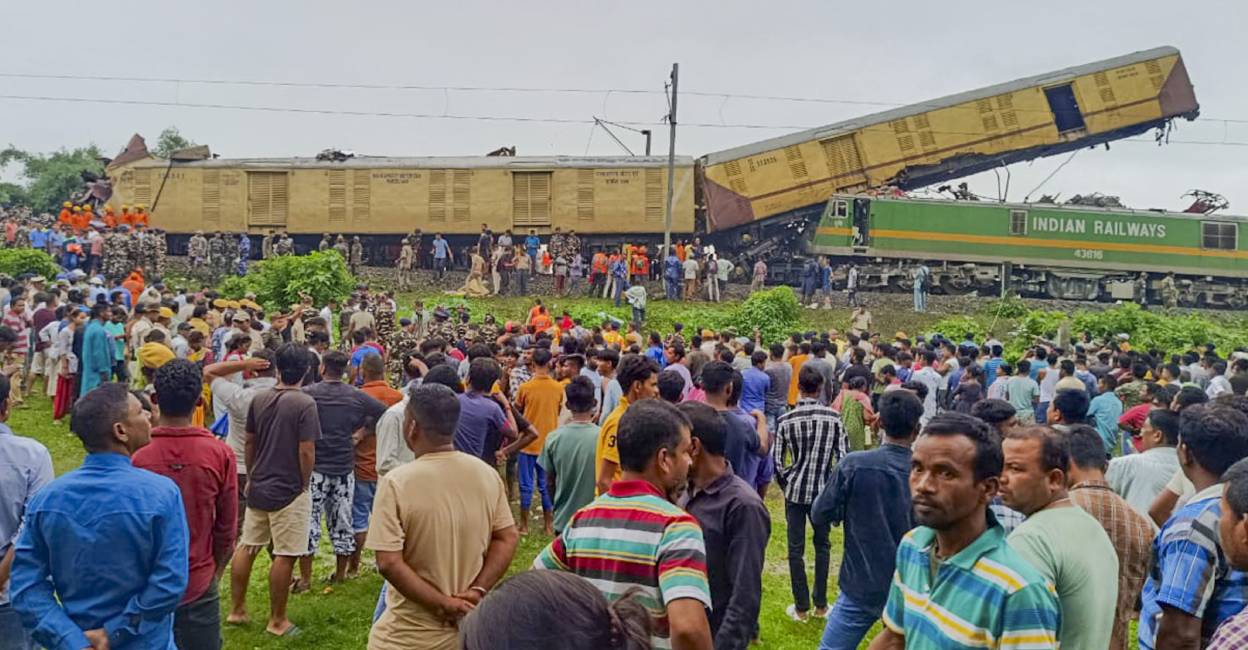 Locals gather after a collision between the Kanchanjungha Express and a goods train, near Rangapani railway station. Photo: PTI