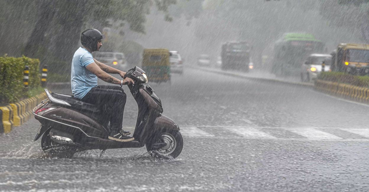 A man rides a two-wheeler amid rains, in New Delhi, Saturday, June 29, 2024. Photo: PTI. 