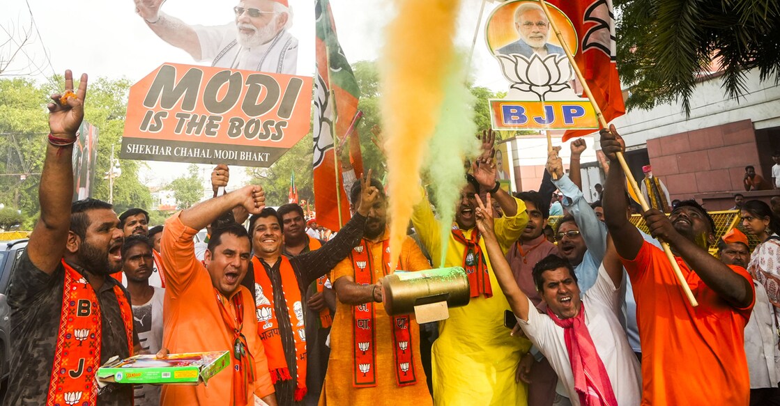 BJP workers celebrate the party's lead during the counting of votes for the Lok Sabha elections. Photo: PTI/Shahbaz Khan