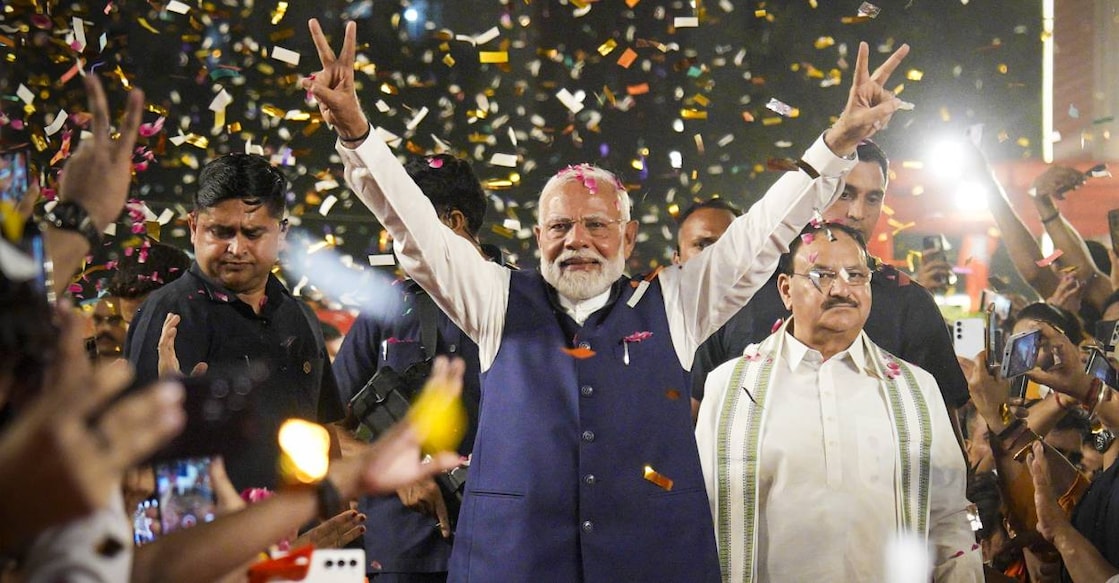 narendra-modi-victory Prime Minister Narendra Modi and BJP National President JP Nadda greet supporters upon their arrival for a meeting at the party headquarters . Photo: PTI