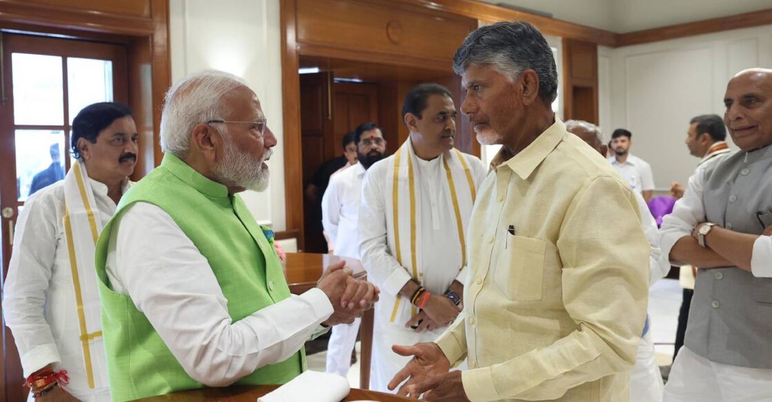 BJP leader Narendra Modi interacts with TDP's Chandrababu Naidu. Photo: PTI