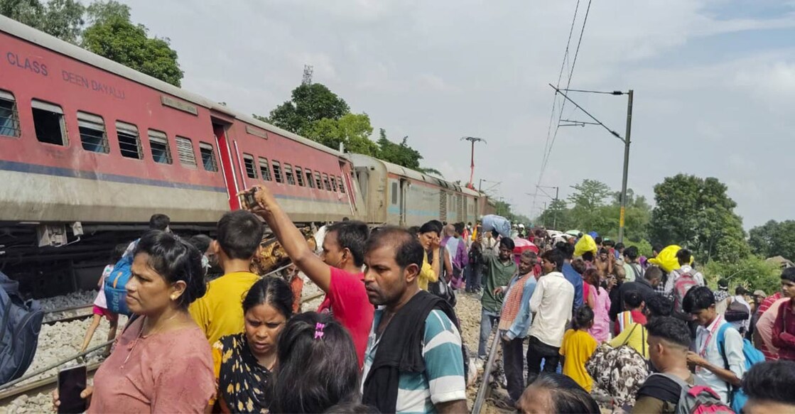 Passengers and locals near the derailed coaches of the Dibrugarh Express train after an accident, in Gonda district, Thursday, July 18, 2024. Photo: PTI. 
