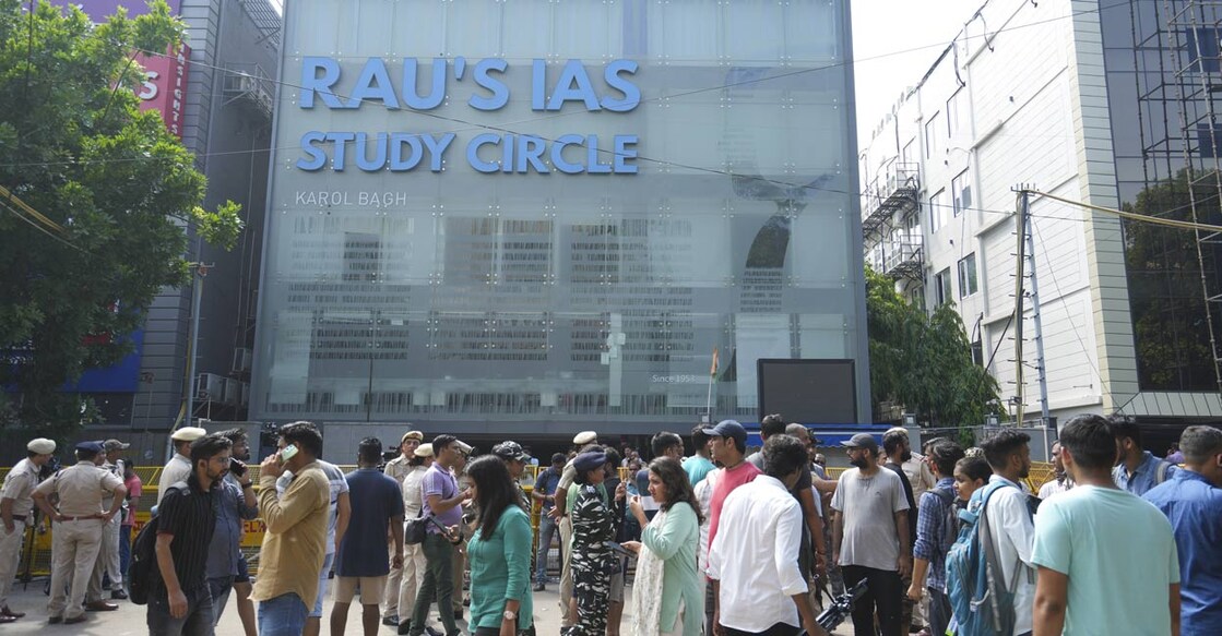 Security personnel stand guard near a UPSC exam coaching centre after three civil services aspirants died when the basement of the coaching centre was flooded by rainwater, in New Delhi, Sunday, July 28, 2024. Photo: PTI. 
