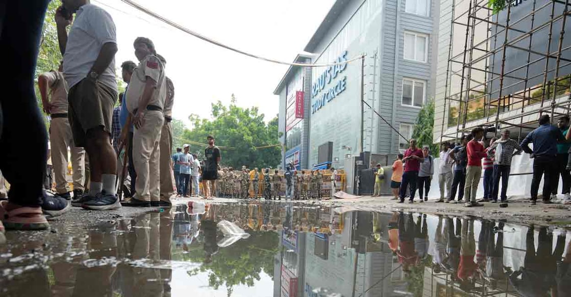 Security personnel stand guard near a UPSC exam coaching centre after three civil services aspirants died when the basement of the coaching centre was flooded following heavy rain, in New Delhi, Sunday, July 28, 2024. Photo: PTI