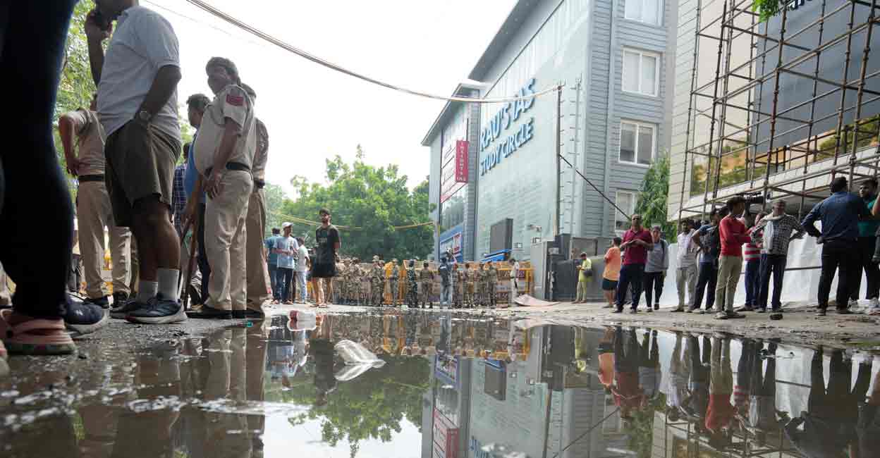 Security personnel stand guard near a UPSC exam coaching centre after three civil services aspirants died when the basement of the coaching centre was flooded following heavy rain, in New Delhi, Sunday, July 28, 2024. Photo: PTI