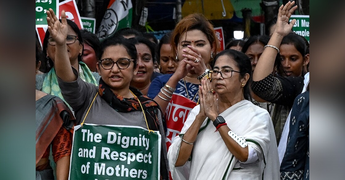 Mamata Banerjee (R), takes part in a protest rally to condemn the rape and murder of a doctor in her state's capital, Kolkata, on August 16, 2024. Photo: DIBYANGSHU SARKAR/AFP.