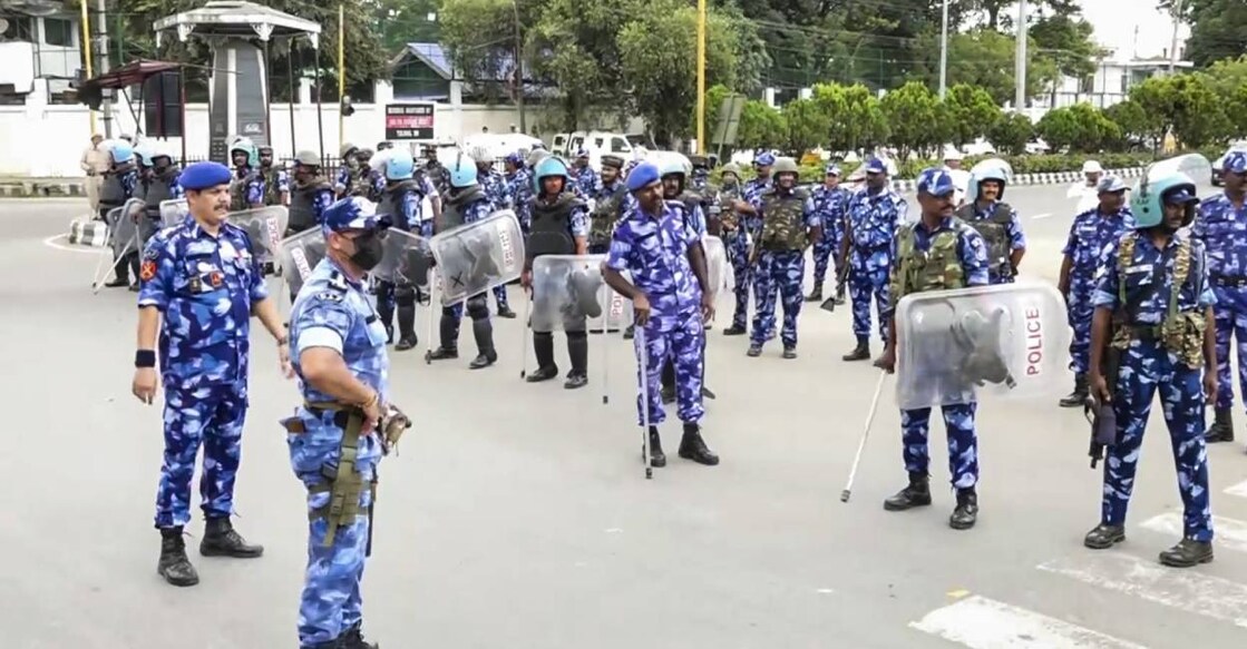  Security personnel keep vigil during a protest march by members of All Manipur Students' Union (AMSU) against the recent violence in the state, in Imphal. Photo: PTI