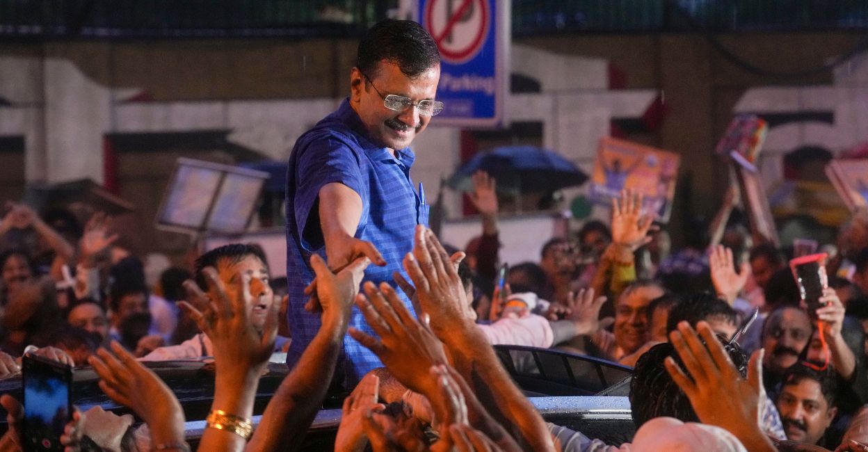 Delhi Chief Minister Arvind Kejriwal acknowledges supporters amid rainfall after walking out of the Tihar Jail, in New Delhi, Friday, September 13, 2024. Photo: PTI