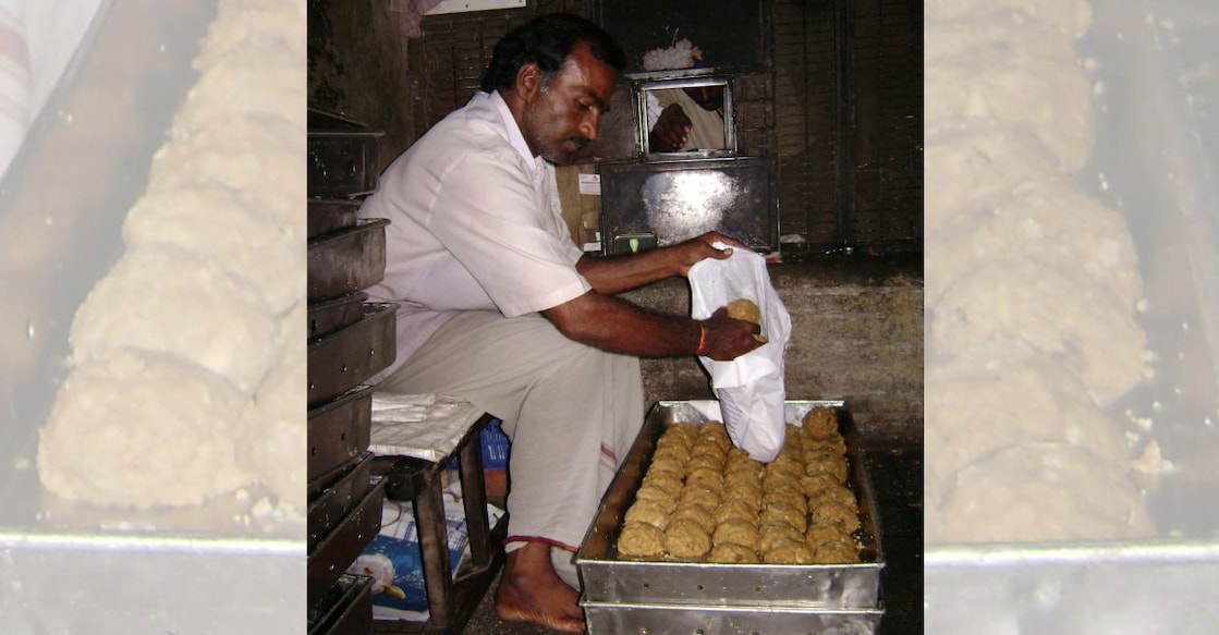 In this file photo a man is packing Tirupati laddu. For representational purpose only. File photo: Manorama