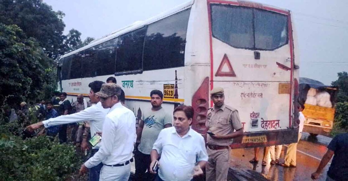 PTI09_06_2024_000294A People gather near the road accident site between a roadways bus and a van on National Highway 93, in Hathras district, Friday, Sept. 6, 2024. Photo: PTI