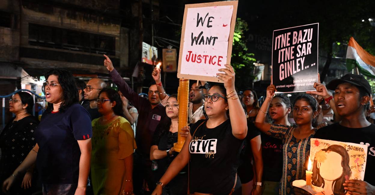 People hold placards as they demonstration to condemn the rape and murder of a doctor, at the RG Kar Medical College and Hospital in Kolkata. Photo: AFP
