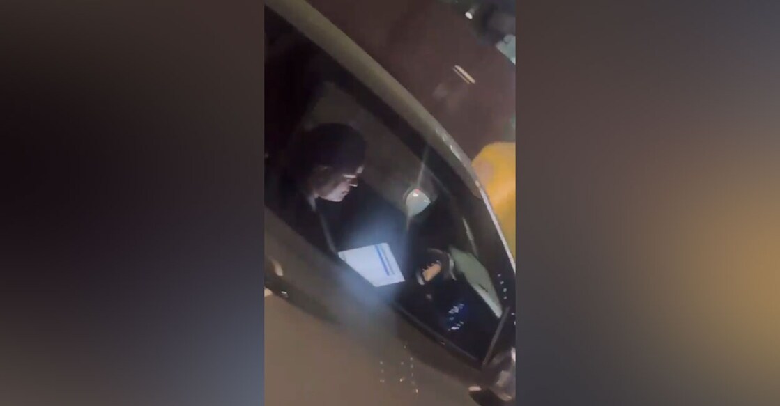 Picture taken from the video footage of a woman caught using a laptop while driving.  Photo: @DCPTrNorthBCP/X.