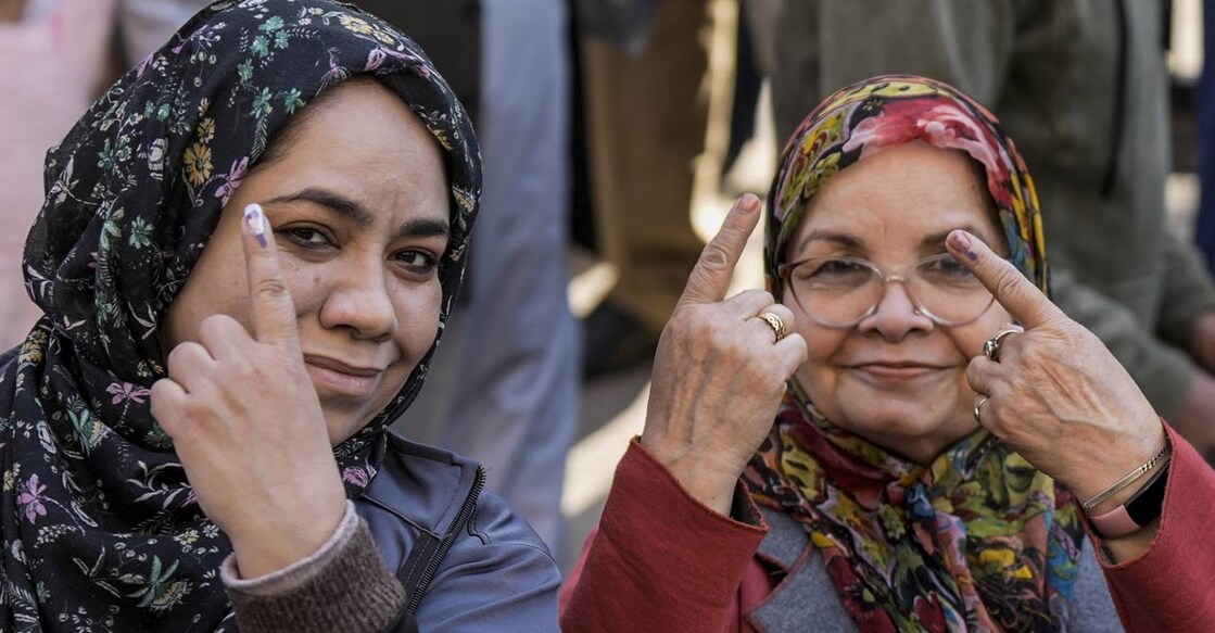 Women voters show their fingers marked with indelible ink after casting votes during the Delhi Assembly elections at Jamia Nagar, Okhla, in New Delhi, Wednesday, Feb. 5, 2025. Photo: PTI. 