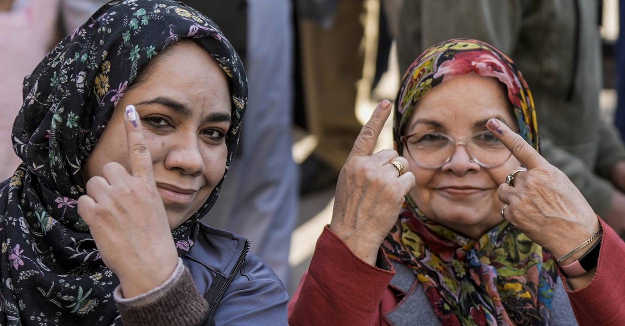 Women voters show their fingers marked with indelible ink after casting votes during the Delhi Assembly elections at Jamia Nagar, Okhla, in New Delhi, Wednesday, Feb. 5, 2025. Photo: PTI. 
