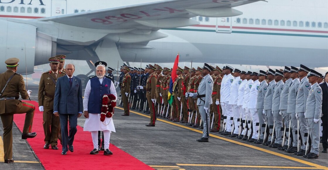 Prime Minister Narendra Modi with his Mauritius counterpart Navin Ramgoolam as he receives a ceremonial welcome upon his arrival, in Mauritius. Photo: @narendramodi on X via PTI