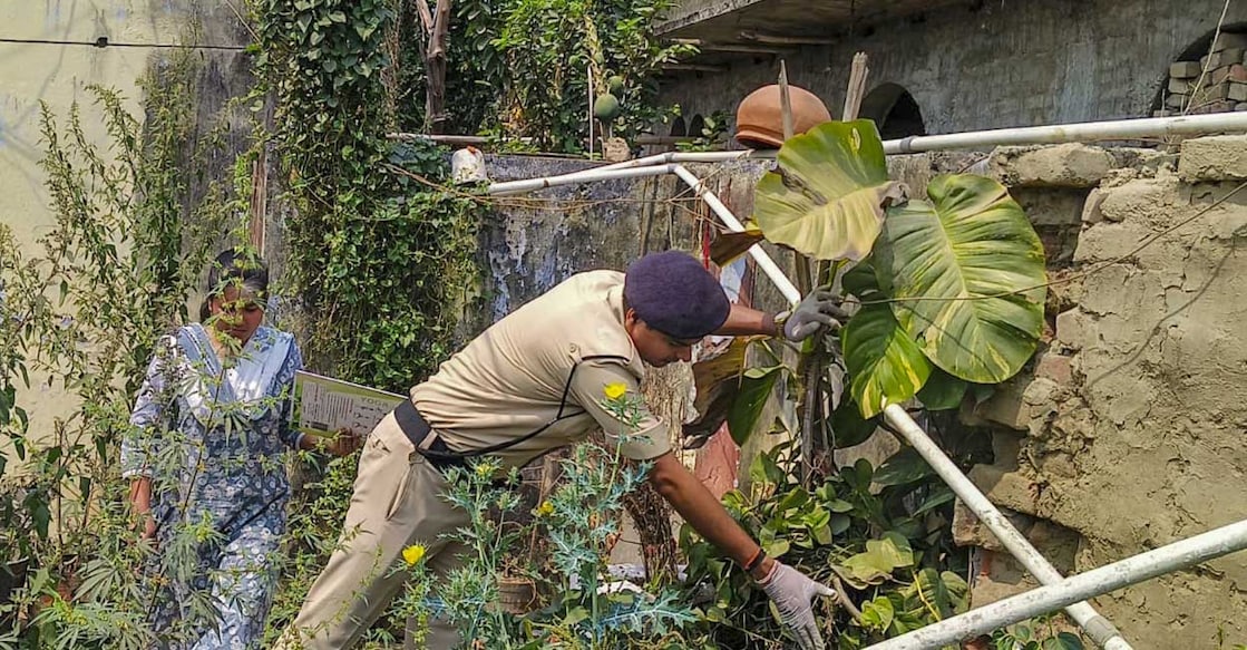 A policeman investigates after relatives of Union Minister Nityanand Rai opened fire at each other. Photo: PTI