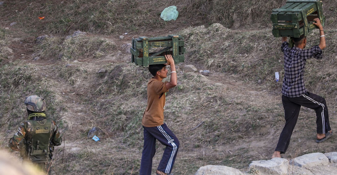 Locals assist security personnel after a fresh gunfight broke out between terrorists and security forces in the Kathua district. Photo: PTI