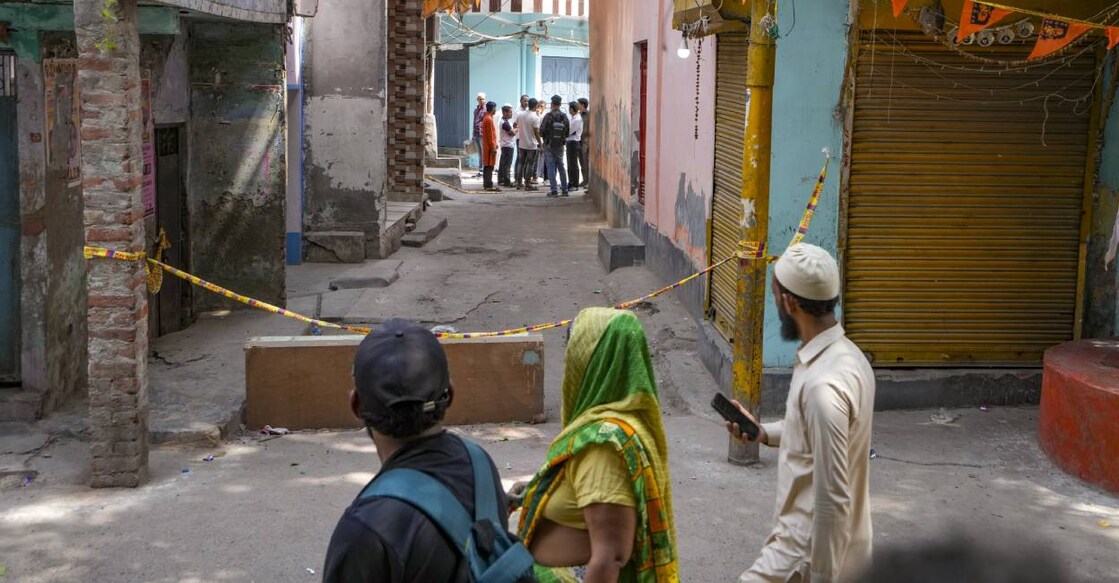 People near the spot where a 17-year-old boy was stabbed to death, in Delhi's Seelampur area, Friday, April 18, 2025. The death sparked protests in the area as police beefed up security following the incident. Photo: PTI