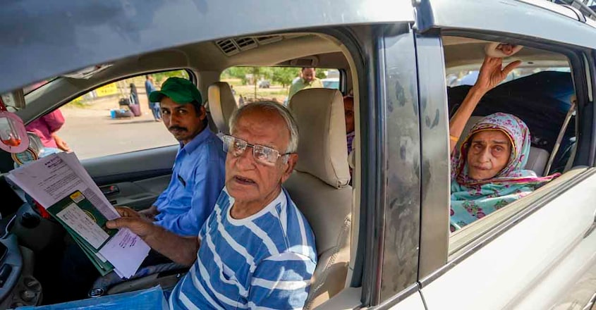 PTI04_25_2025_000065B People wait for clearance to cross the border at the Integrated Check Post at the Attari-Wagah border to move to Pakistan on April 25, 2025. Photo: PTI Photo/Shiva Sharma