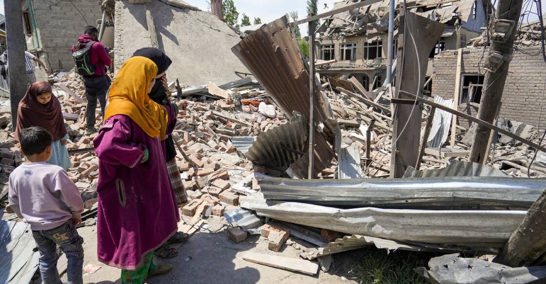 People near the house of Ahsan Ul Haq Sheikh, a suspect in the Pahalgam terror attack, which was razed in a blast, in Murran area of Pulwama district. Photo: PTI