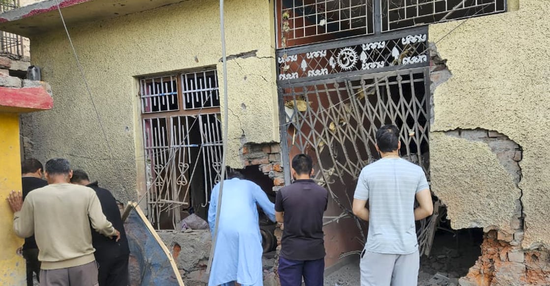 People gather after alleged heavy firing and shelling by Pakistan military overnight across the LoC and International Border in Rajouri in Jammu and Kashmir on Wednesday. Photo: PTI