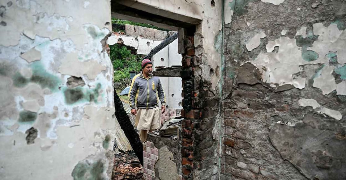 A man walks through his house destroyed by Pakistani artillery shelling at the Salamabad village in Uri, about 110kms from Srinagar, on May 8, 2025. Photo: AFP/Sajjad Hussain