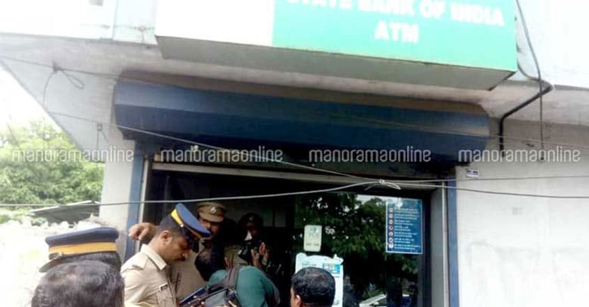 Rs 35 lakh robbed from ATMs in Kochi, Thrissur Police look for clues at the SBI ATM at Irumpanam from where Rs 25 lakh was stolen.