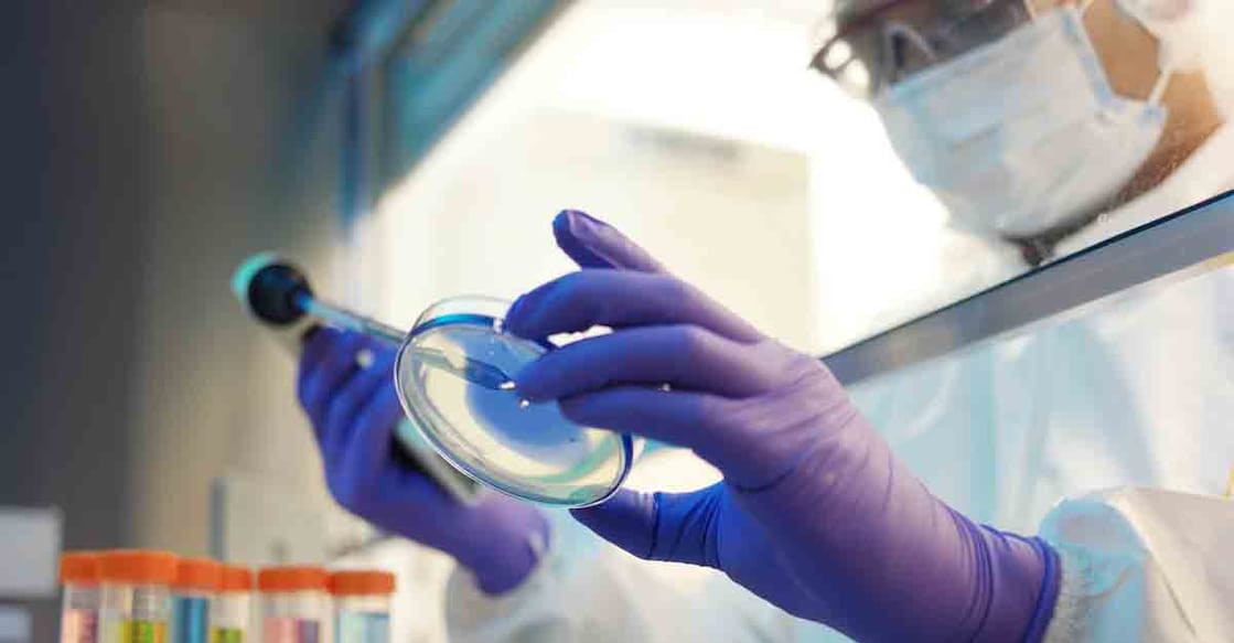 Male scientist in a cleanroom laboratory