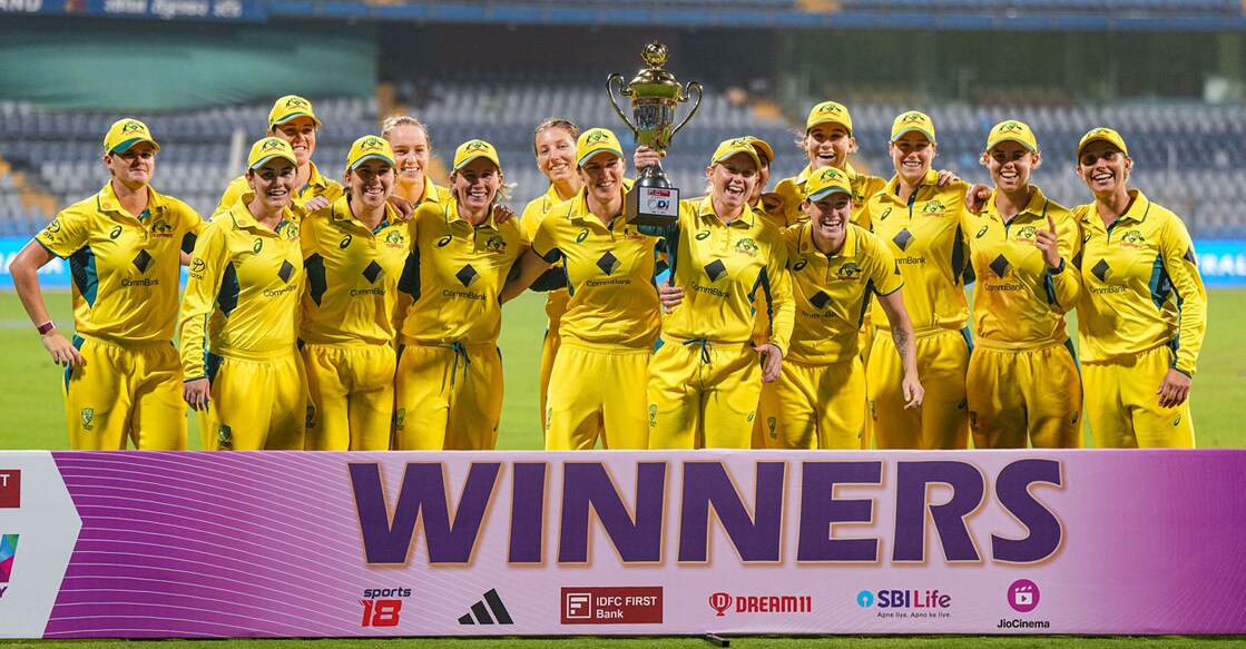 Australian players pose with the trophy after winning the 3-match ODI series against India at the Wankhede Stadium in Mumbai on Tuesday. Photo: PTI