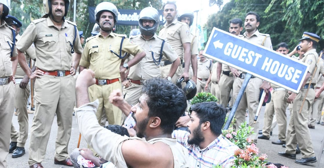 Kerala Police officers watch as SFI activists protest at the Calicut University campus on Saturday. Photo: Facebook/@pmarshoofficial