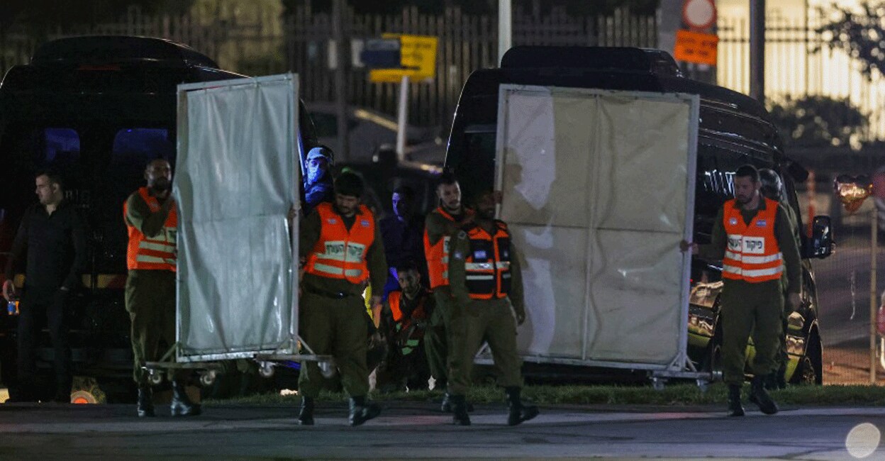 ISRAEL-PALESTINIAN-CONFLICT-HOSTAGES Israeli security forces carry privacy screens at the helipad outside Tel Aviv's Schneider medical centre on November 24, 2023, amid preparations for the release of Israeli hostages held by Hamas in Gaza in exchange for Palestinian prisoners later in the day. Photo: AFP/ Jack Guez