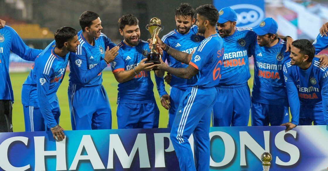 Indian players celebrate with the trophy after winning the 5-match T20I series against Australia, at M Chinnaswamy Stadium in Bengaluru on Sunday. Photo: PTI