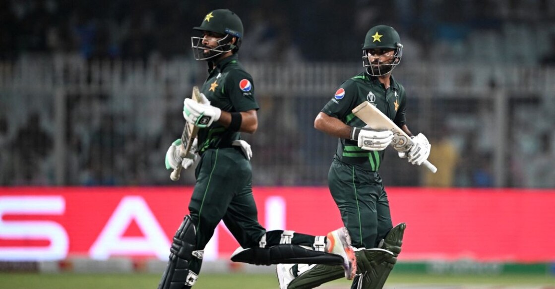 Pakistan's Fakhar Zaman (right) and Abdullah Shafique run between the wickets during the ICC Men's Cricket World Cup match against Bangladesh at the Eden Gardens in Kolkata Tuesday. Photo: AFP/Dibyangshu Sarkar