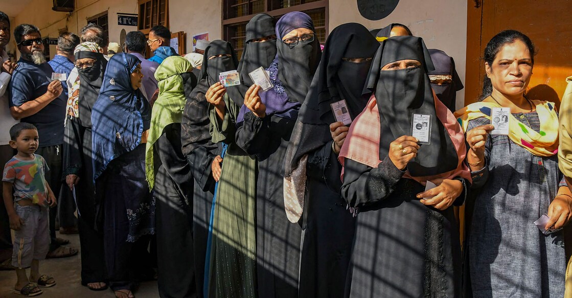 People wait in a queue to cast their votes at a polling station during the 3rd phase of Lok Sabha polls in Karnataka on Tuesday. Photo: PTI