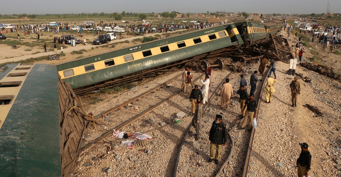 Police officials inspect the carriages at the accident site following the derailment of a passenger train in Nawabshah in southern Pakistan on Sunday. Photo: AFP/Husnain Ali