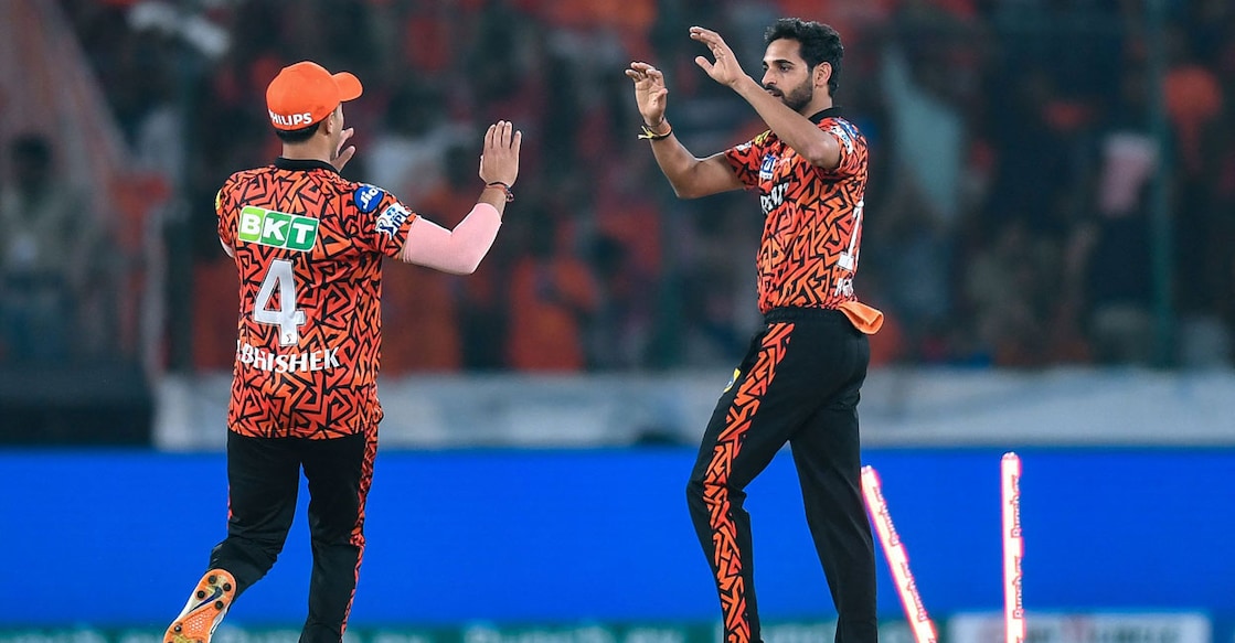 Sunrisers Hyderabad's Bhuvneshwar Kumar celebrates with his teammate Abhishek Sharma after taking the wicket of Rajasthan Royals' captain Sanju Samson. Photo: AFP