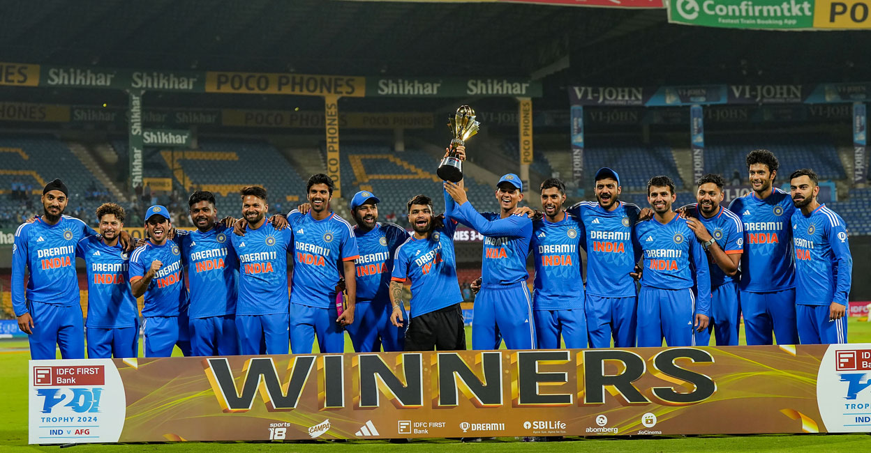 PTI01_18_2024_000650A Indian team players pose with the tournament trophy after winning the third T20I against Afghanistan at M Chinnaswamy Stadium in Bengaluru on Wednesday. Photo: PTI