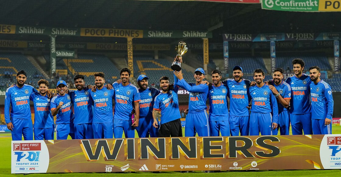 Indian team players pose with the tournament trophy after winning the third T20I against Afghanistan at M Chinnaswamy Stadium in Bengaluru on Wednesday. Photo: PTI