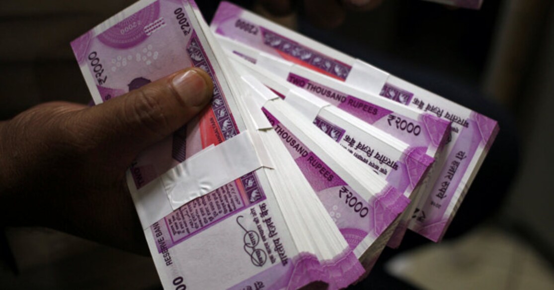 A cashier displays the new 2000 Indian rupee banknotes inside a bank in Jammu, India November 15, 2016. REUTERS/Mukesh Gupta