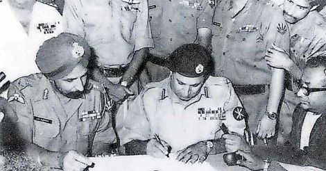 Pak Lieutenant General Amir Niazi signs the surrender agreement after the Bangladesh war in 1971. Indian Lieutenant General Jagjit Singh Aurora looks on.
